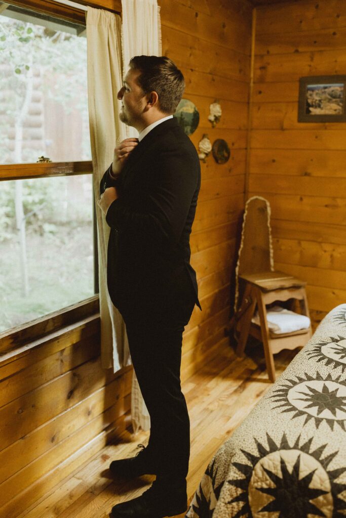 groom getting ready for her Flying Moon Cabins elopement