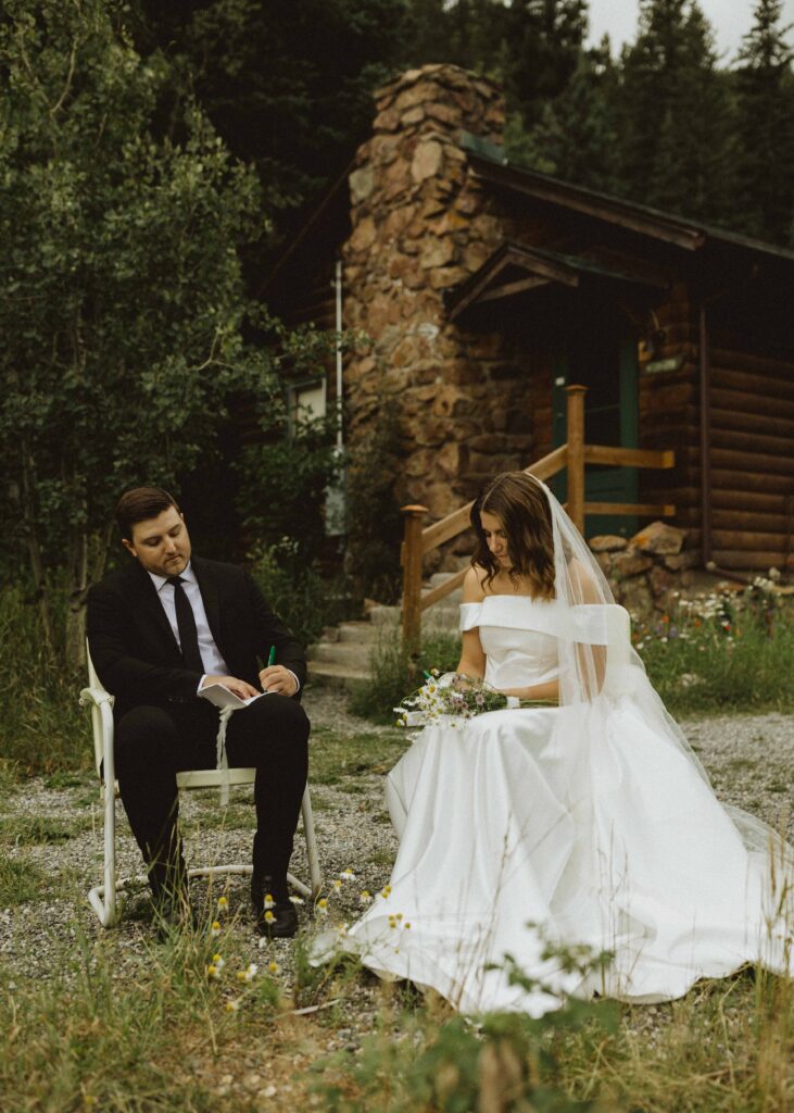 bride and groom writing vows for their cabin elopement at flying moon cabins