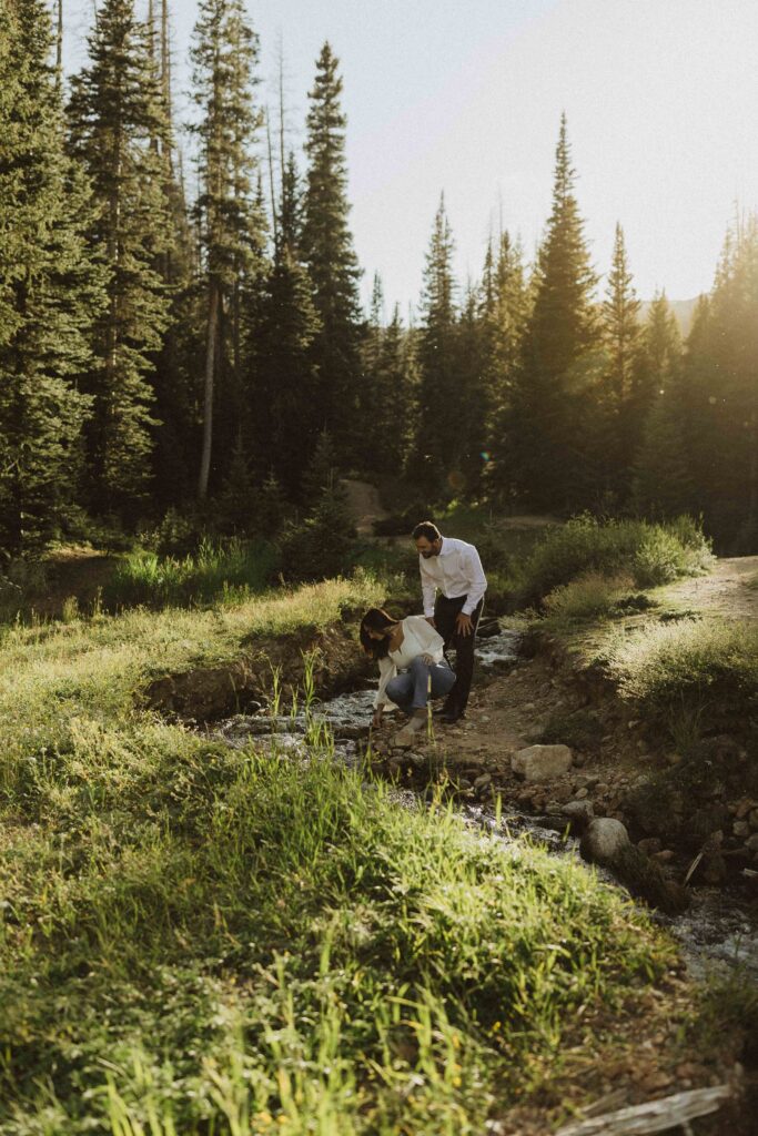 a couple exploring the creek for their engagement photos in Estes Park Colorado