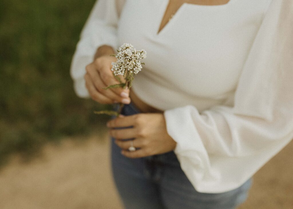 girl holding flower for her engagement photos