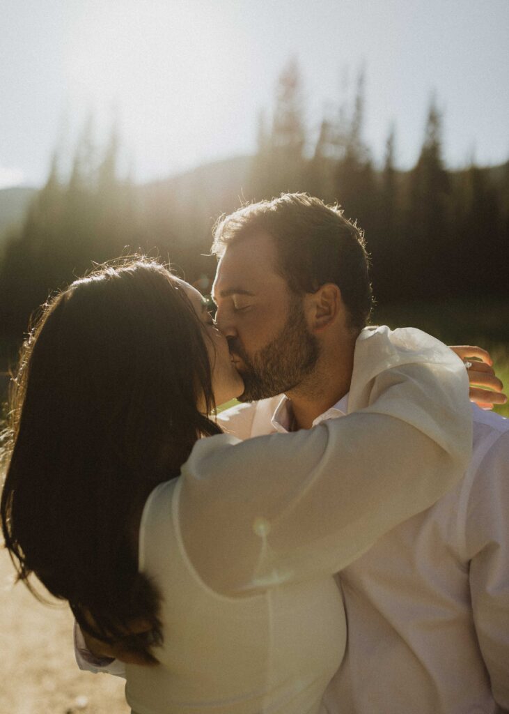 a couple posing for their engagement photos in Estes Park Colorado