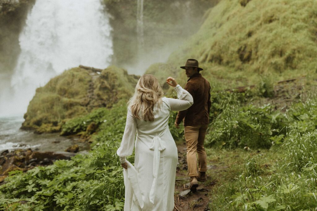 Sahalie Falls Elopement Couple Exploring the Waterfall