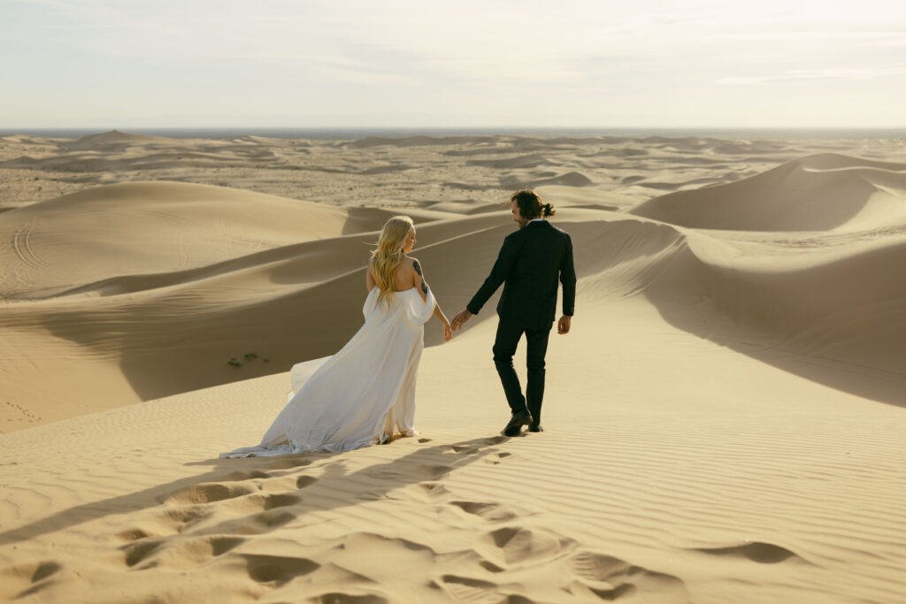 Couple taking destination engagement photos at Imperial Sand Dunes