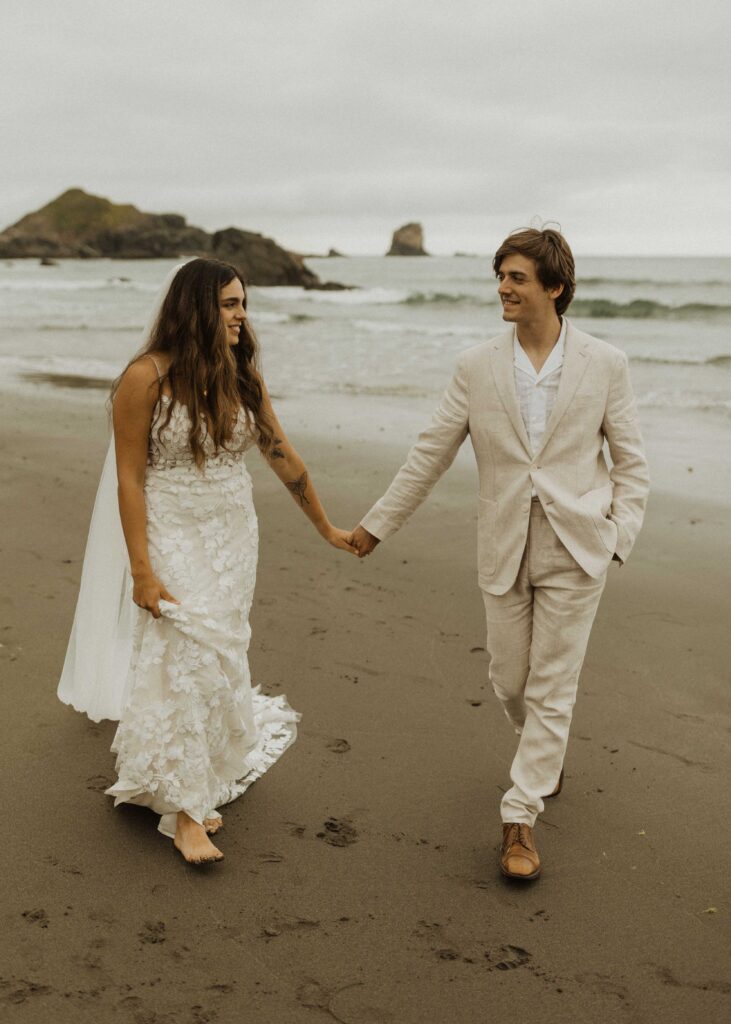 couple walking on the beach during their brookings oregon beach elopement