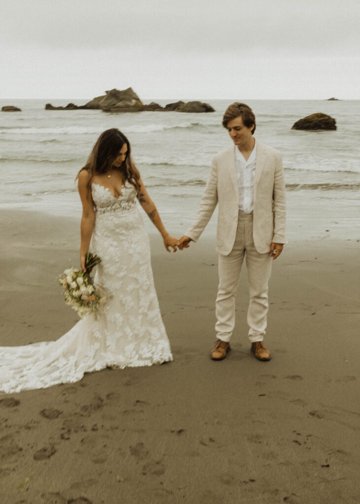 couple walking on the beach during their brookings oregon beach elopement