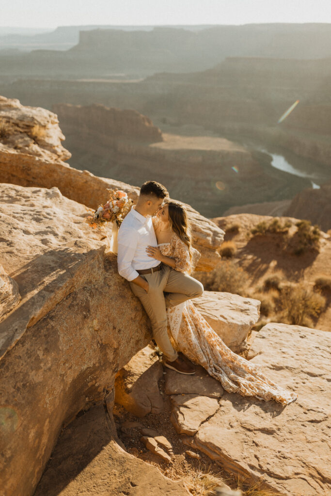 couple taking wedding photos at dead horse point in Moab
