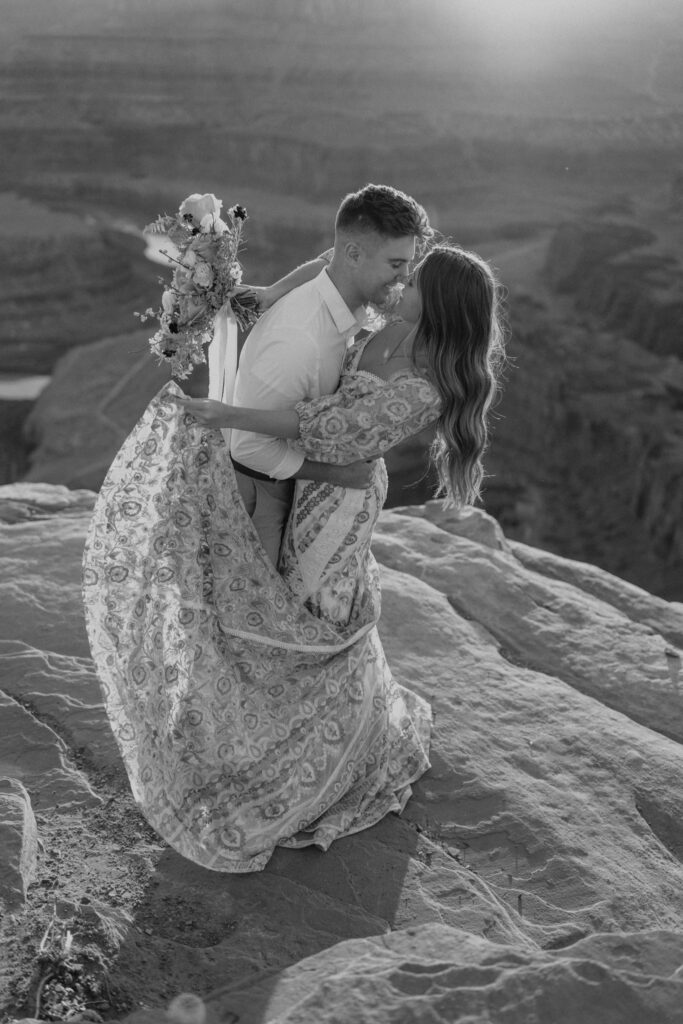 couple taking wedding photos at dead horse point in Moab