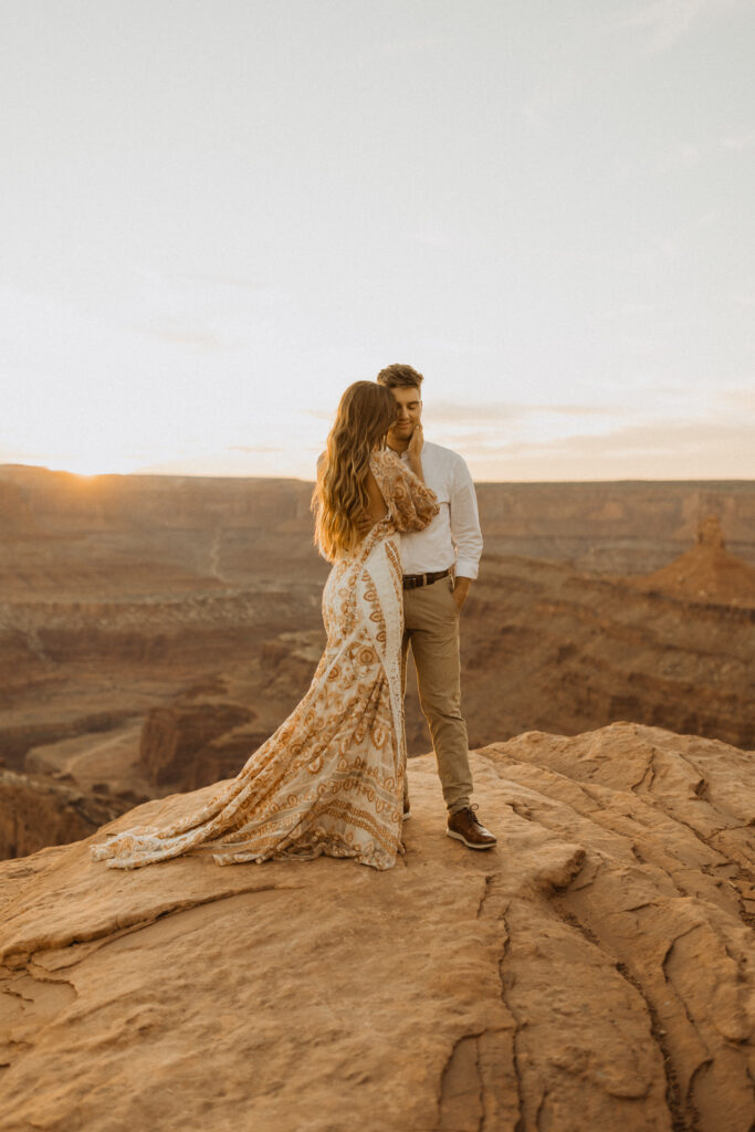 bride taking wedding photos at dead horse point in Moab