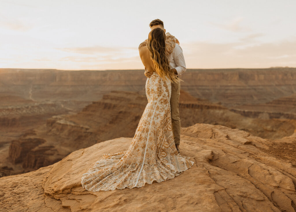 couple taking wedding photos at dead horse point moab