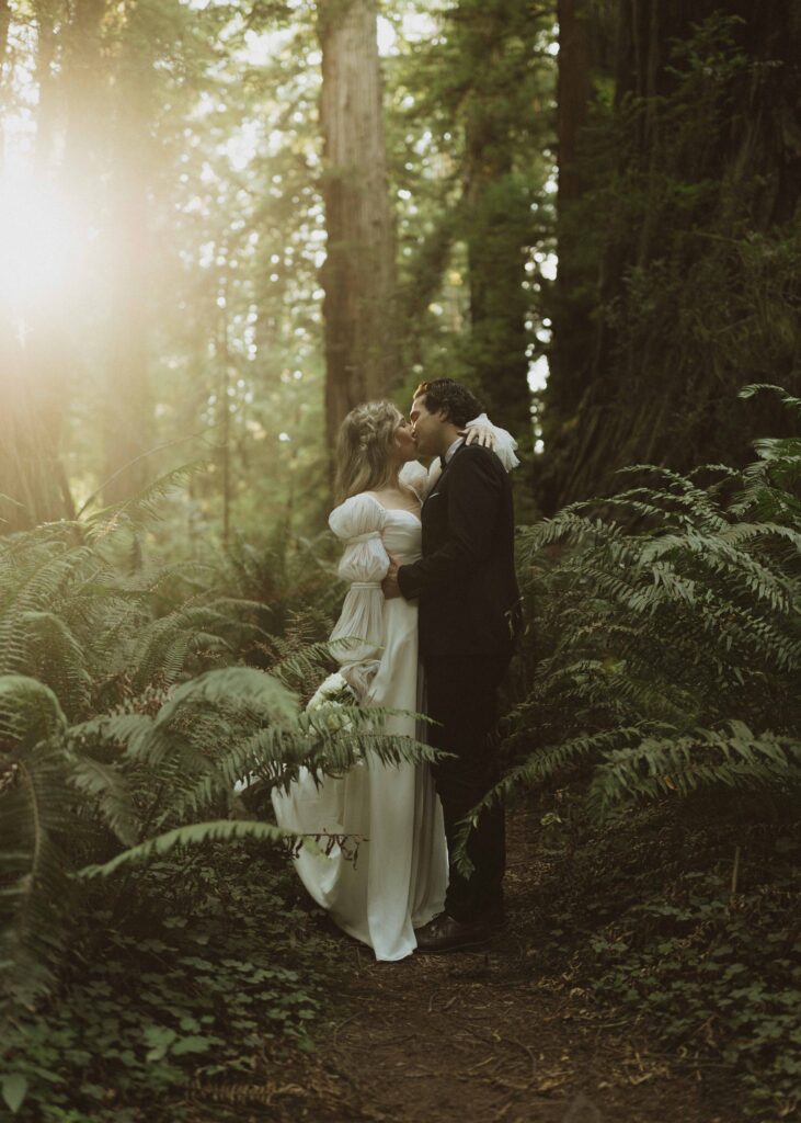 couple kissing during photos at their redwoods elopement 