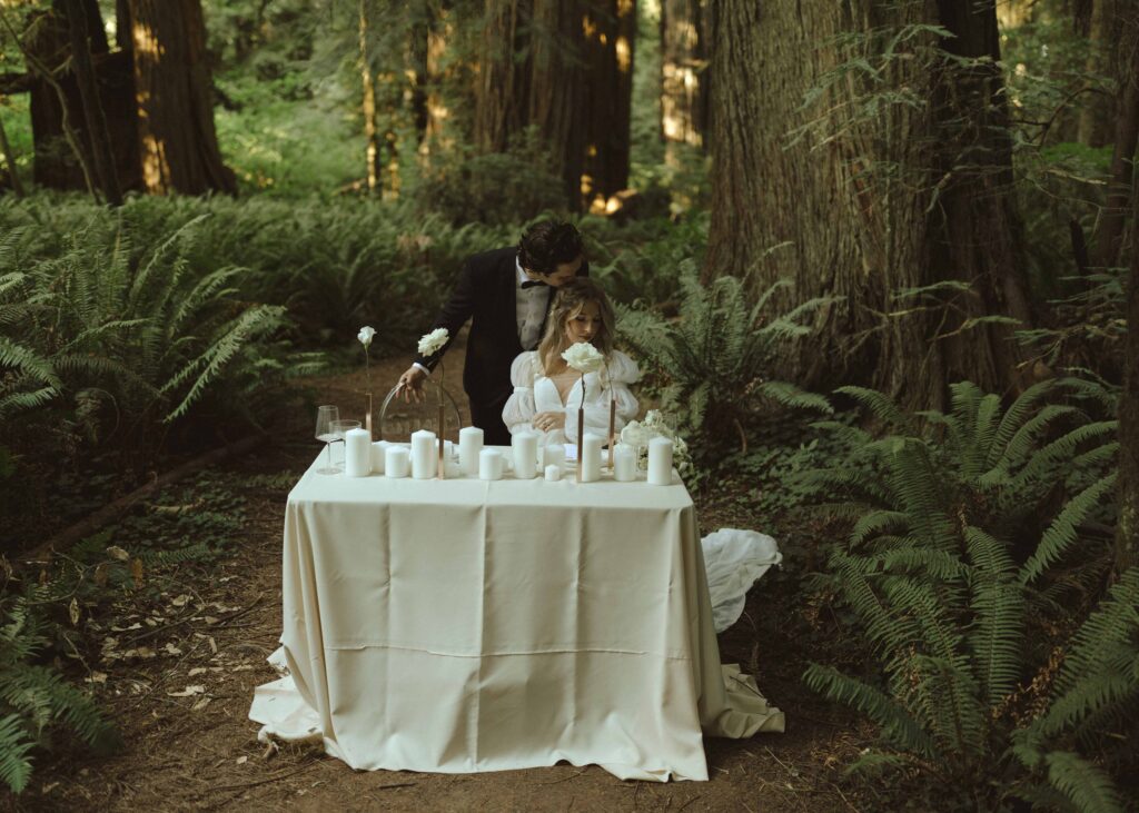 couple eating dinner in the redwoods for their luxury elopement 
