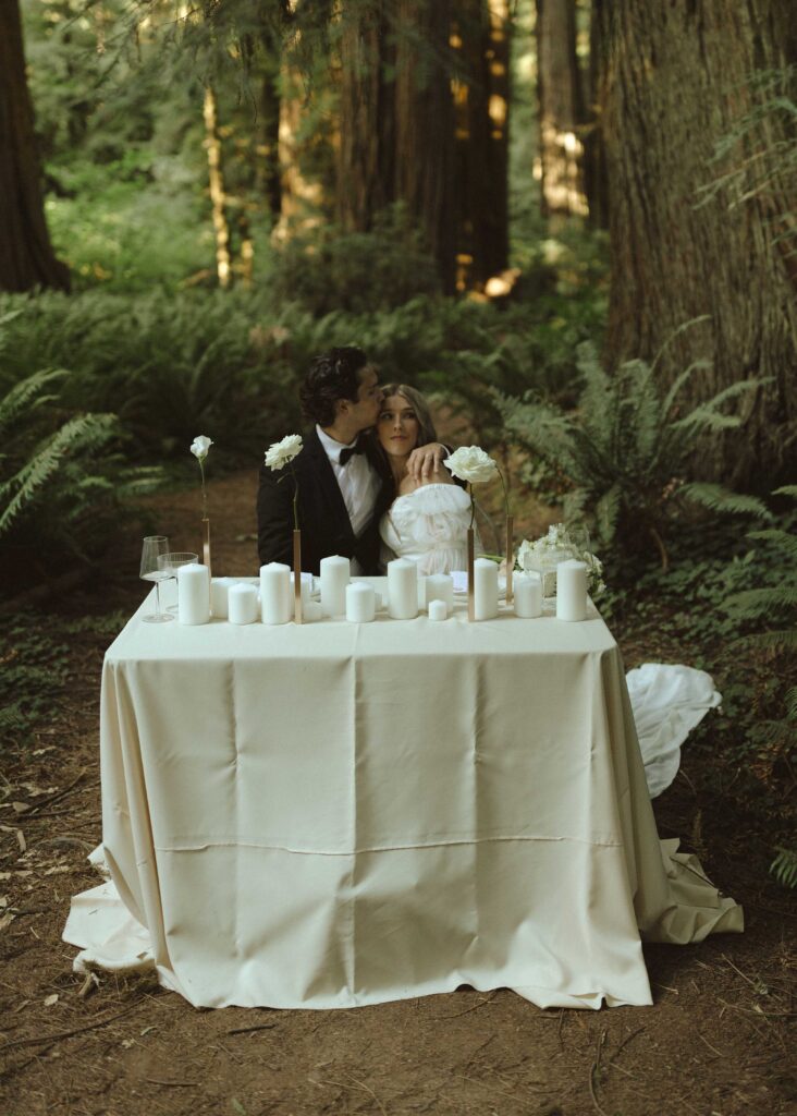 couple eating dinner at their luxury redwoods elopement  