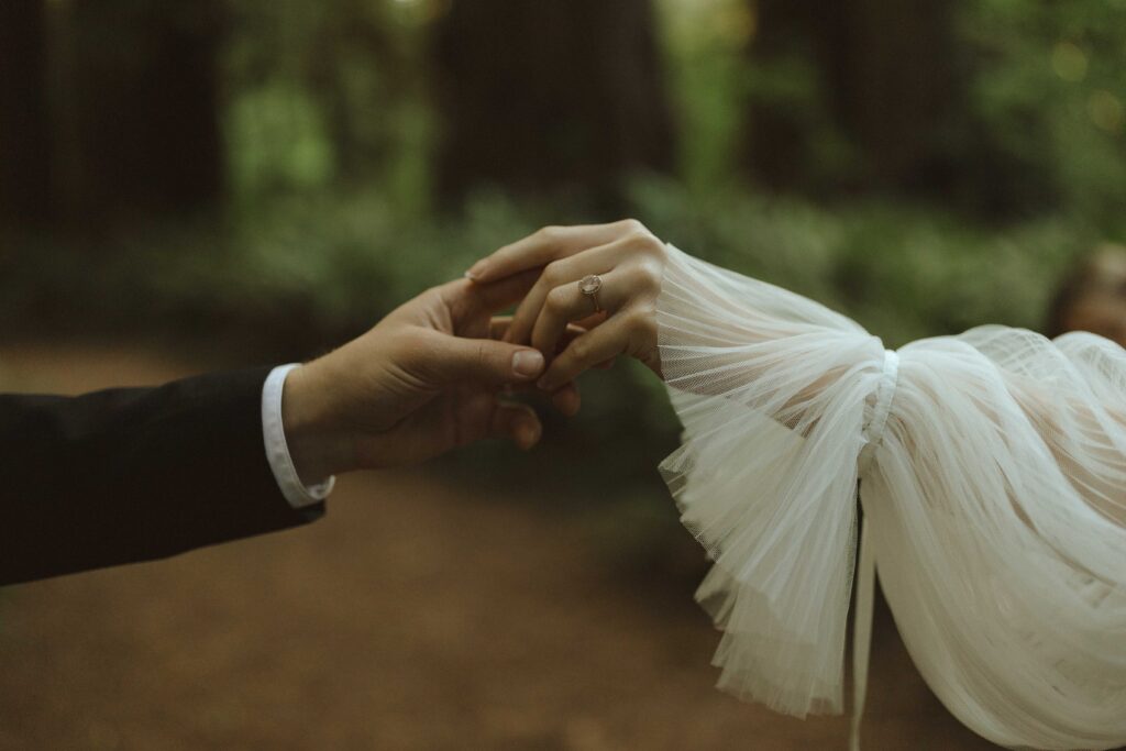 close up of a bride and grooms hands at a redwoods elopement 