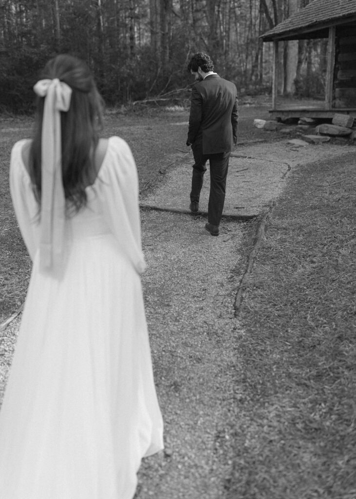 bride and groom taking photos at a cabin after their cades cove wedding