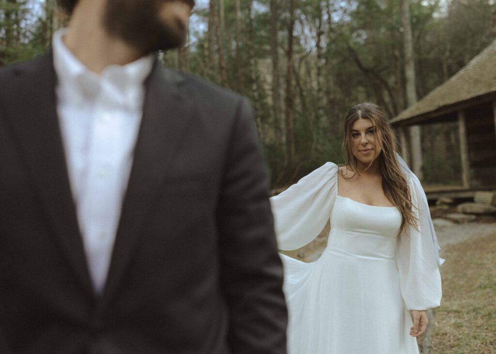 bride and groom taking photos at a cabin after their cades cove wedding