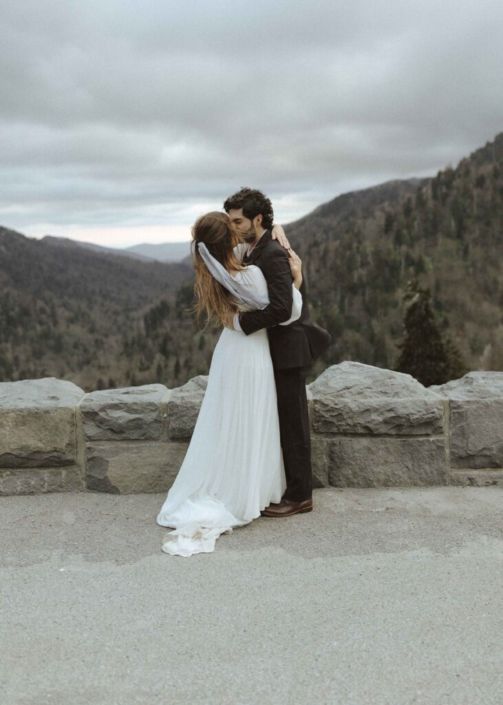bride and groom taking photos at the top of the park at Great Smoky Mountains 