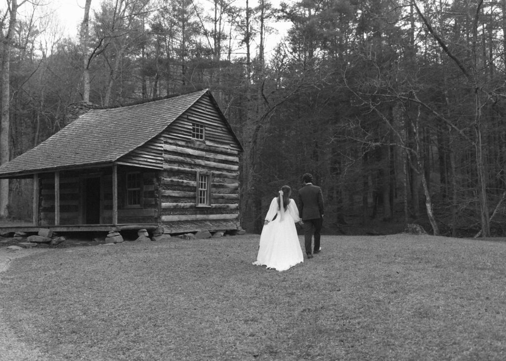 bride and groom taking photos at a cabin in the great smoky mountains 