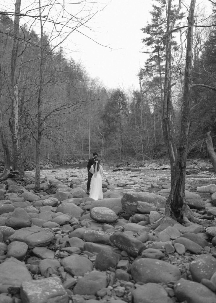 couple walking along the river at their great smoky mountains elopement 