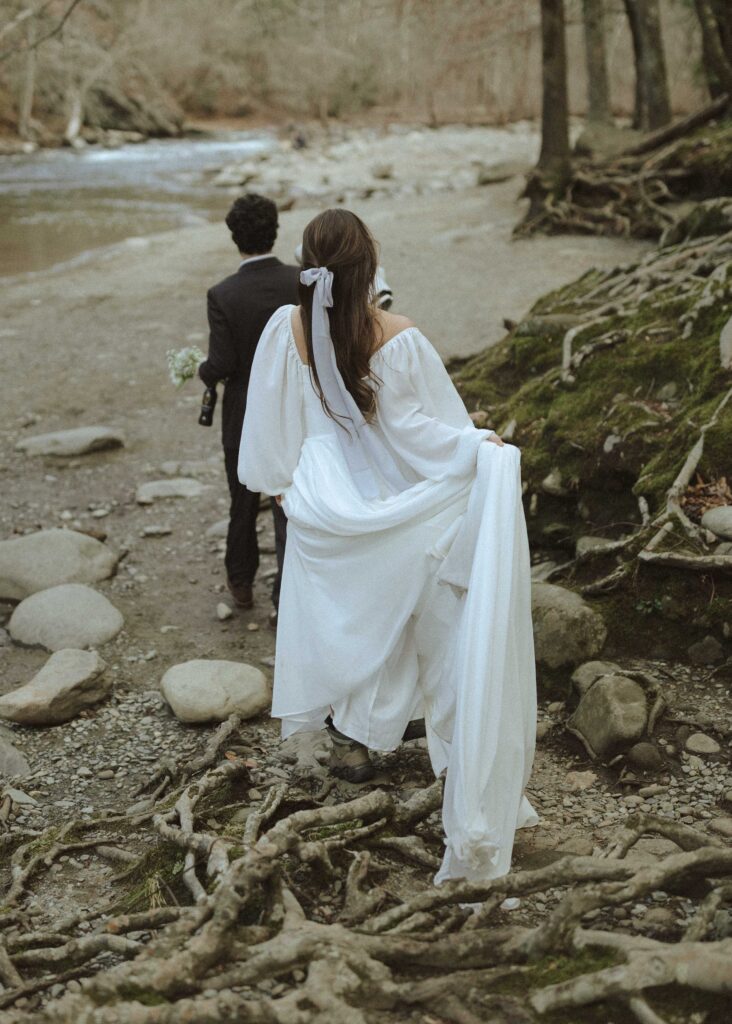 couple walking along the river at their great smoky mountains elopement 