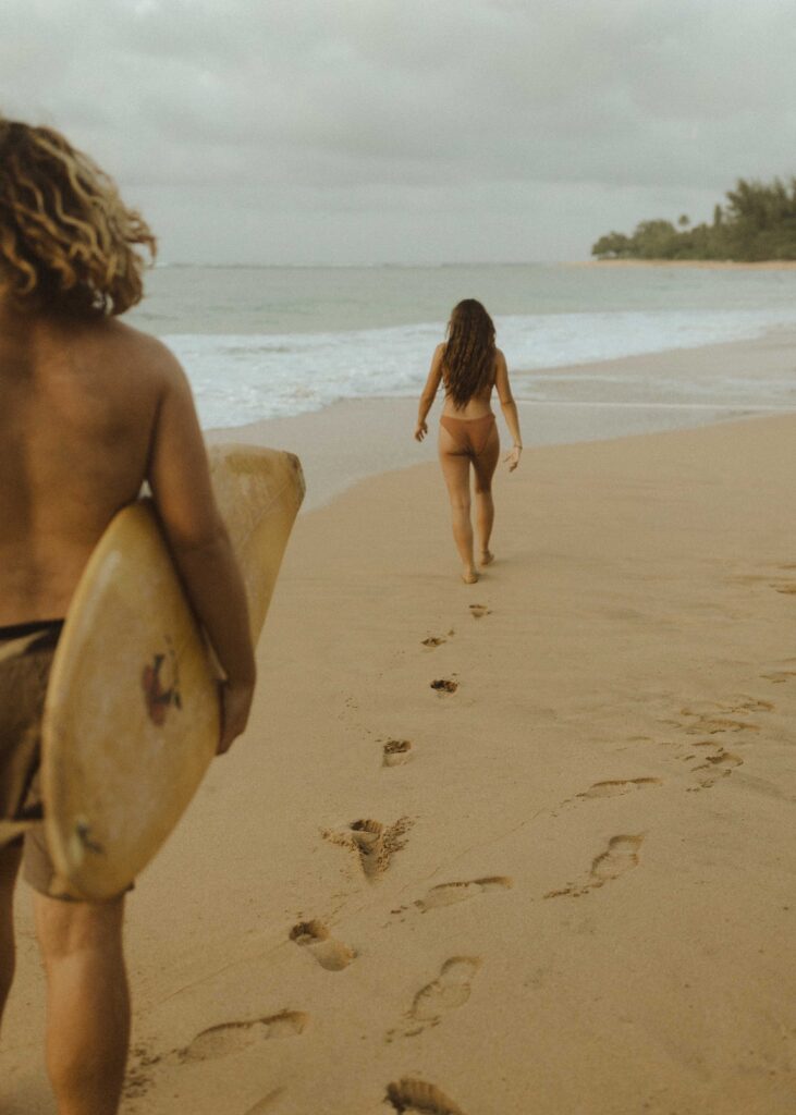 couple walking on the beach for their kauai couples session