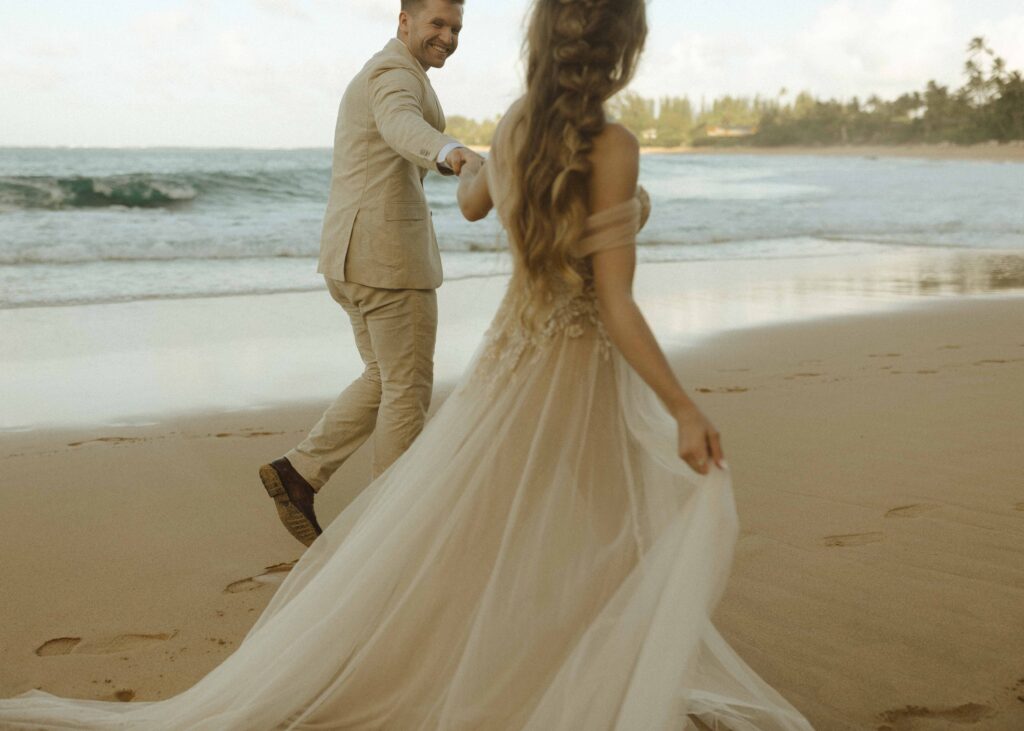 couple walking on the beach for their tunnels beach wedding