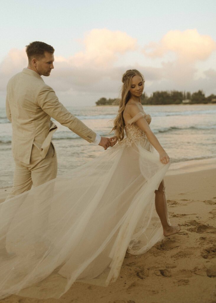 couple walking on the beach for their tunnels beach wedding