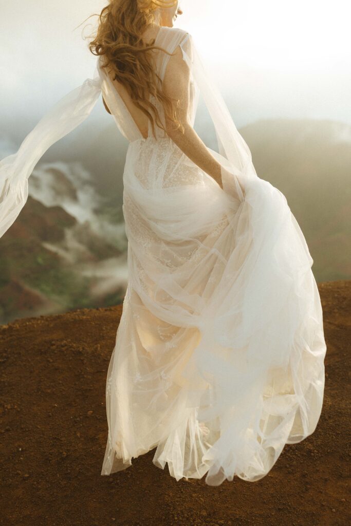 bride walking during her waimea canyon elopement 