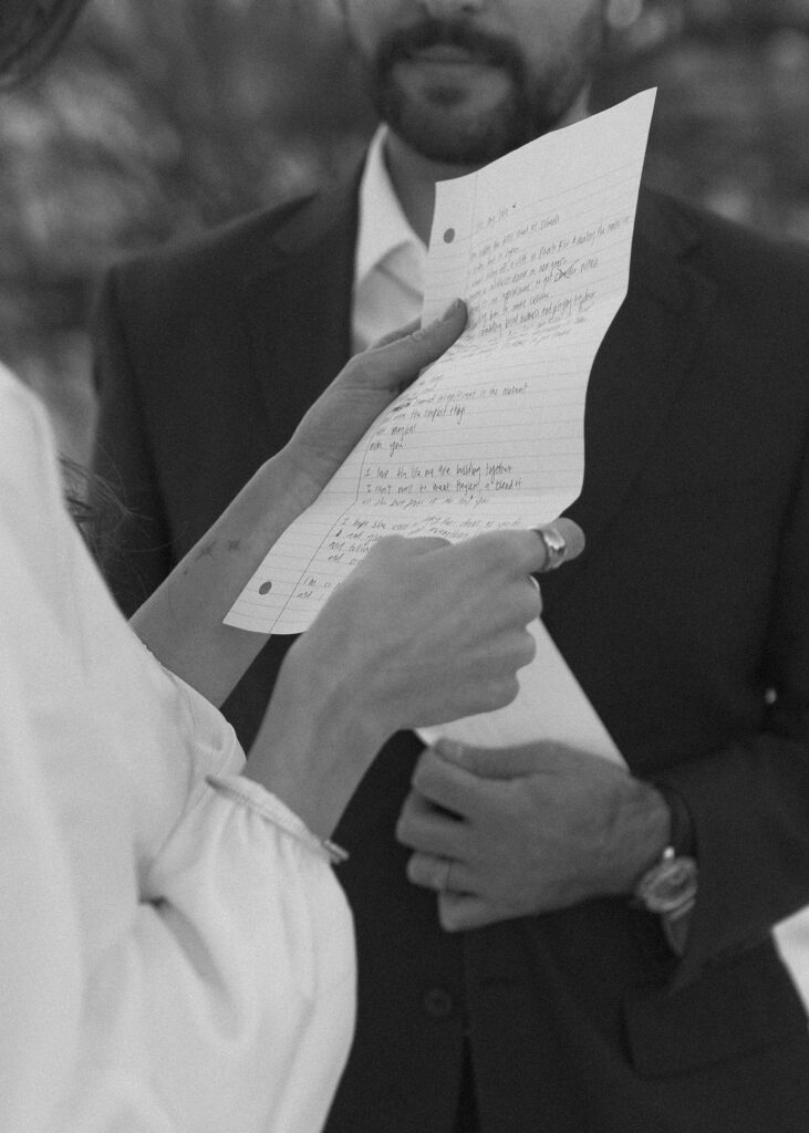 bride and groom reading vows at their winter cabin elopement 