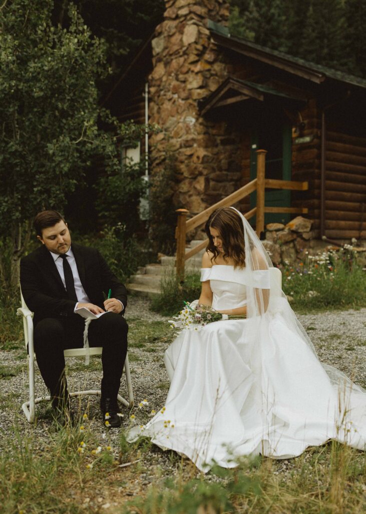 couple writing their vows at their Colorado cabin Airbnb