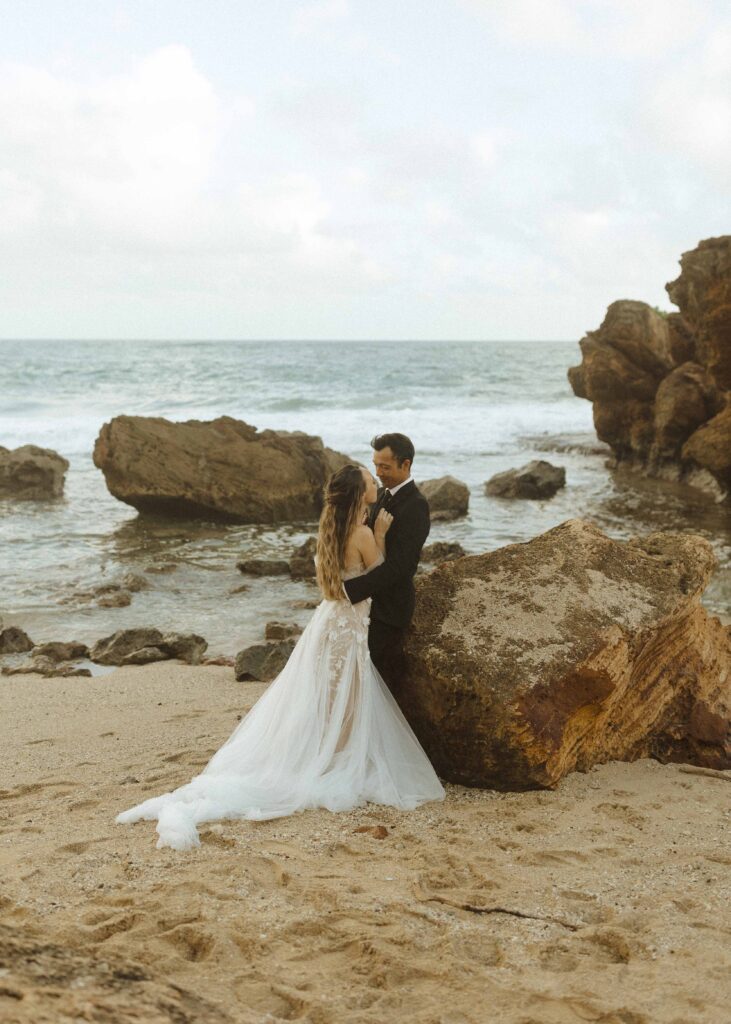 bride and groom taking photos at their south shore elopement in kauai 