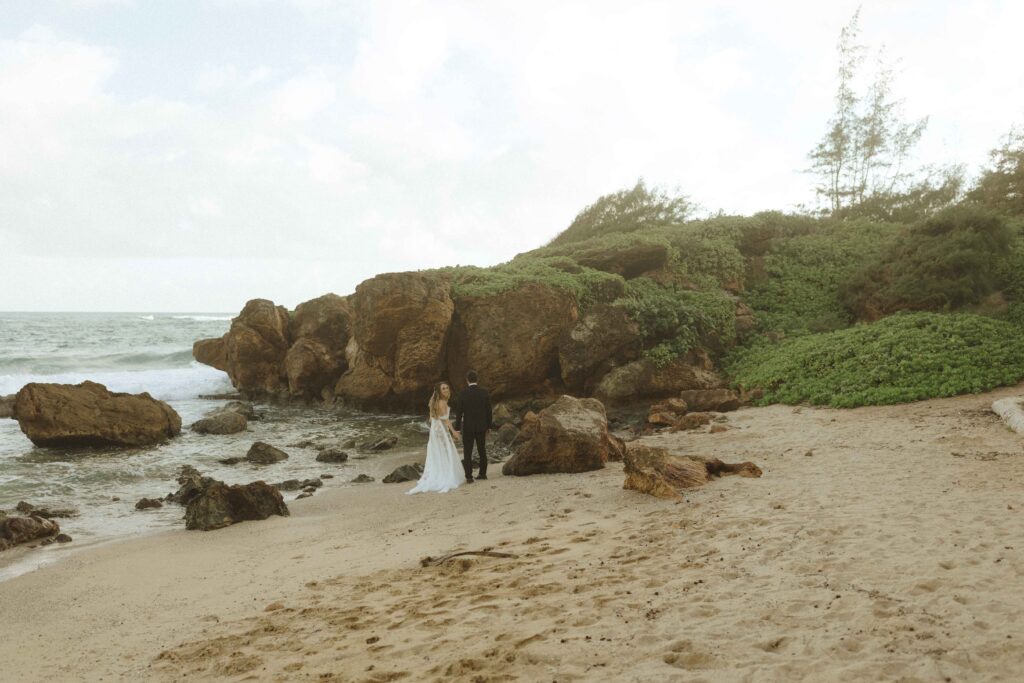 bride and groom walking for their south shore kauai elopement 