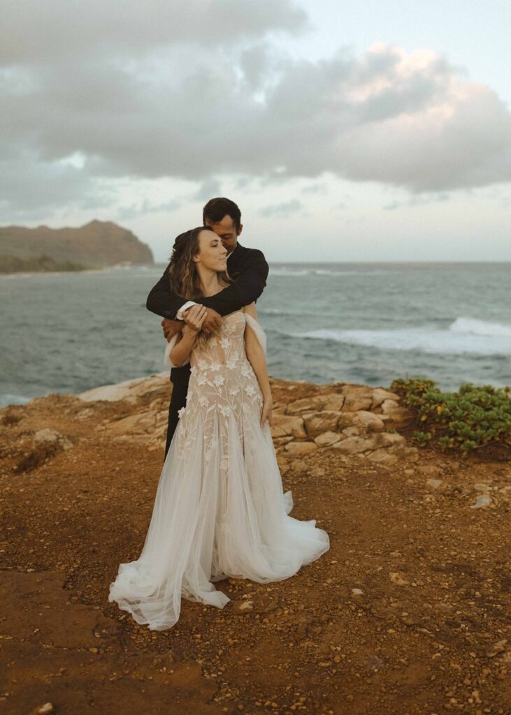 bride and groom taking photos at their south shore elopement in kauai 