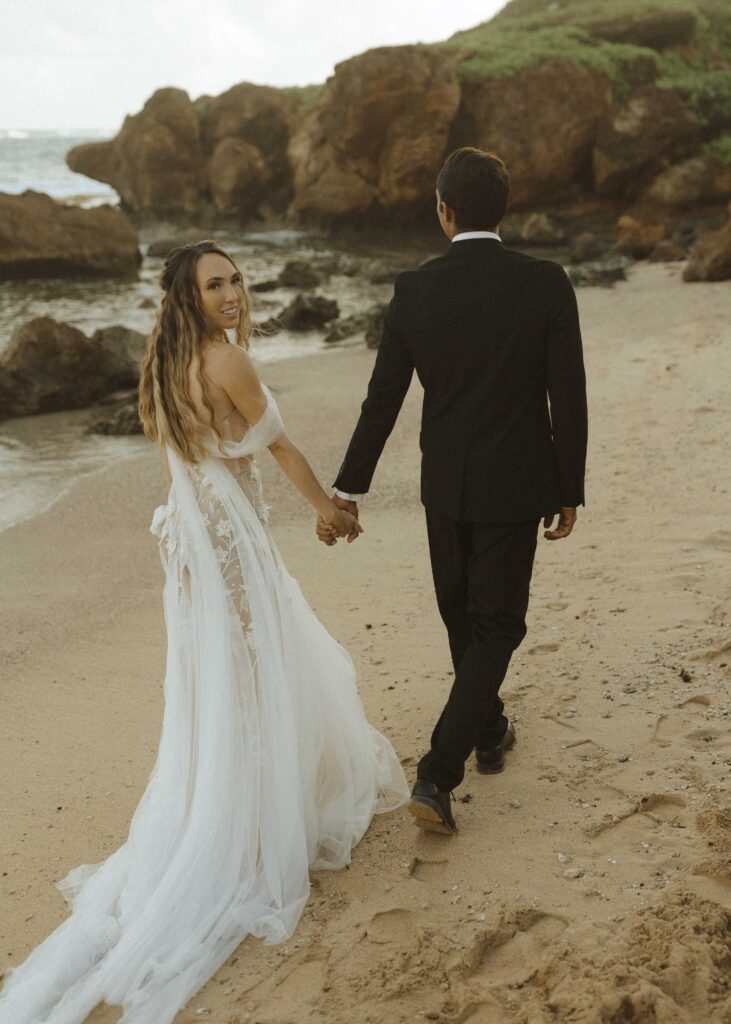 bride and groom walking for their south shore kauai elopement 