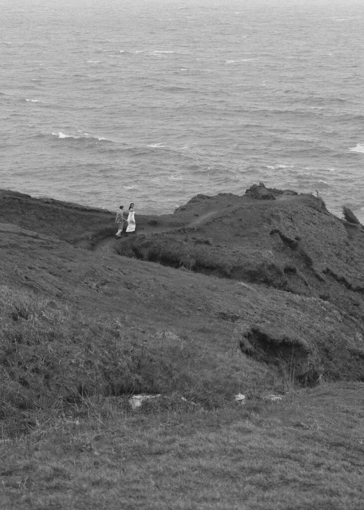 couple walking for their Oregon cliffside elopement 