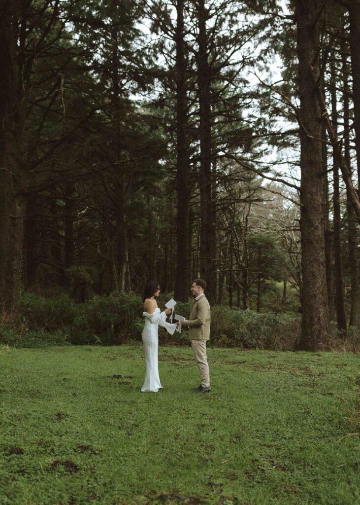 couple reading vows for their Oregon cliffside elopement 