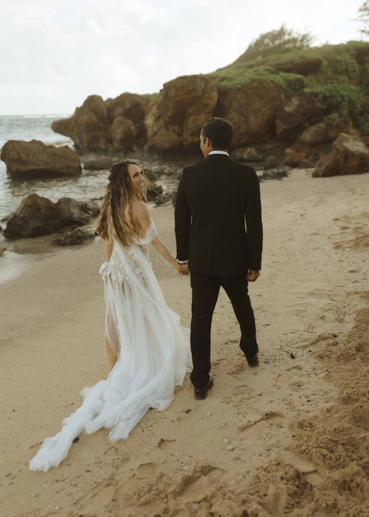 couple walking on the beach for their Kauai Wedding 