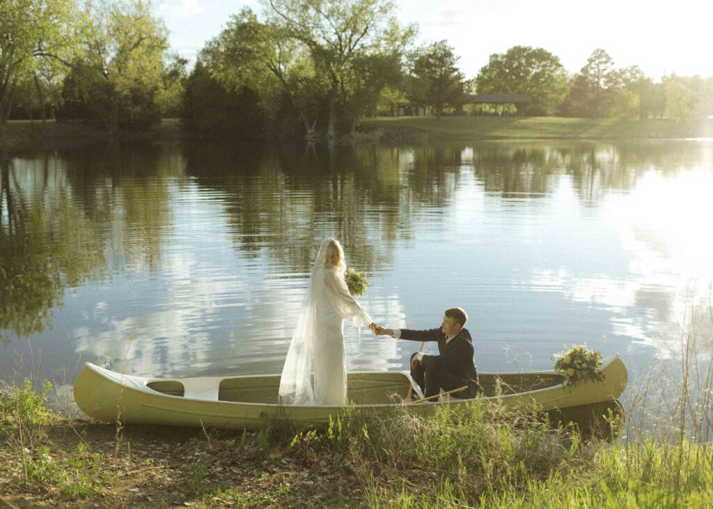 bride and groom taking photos at their canoe elopement 