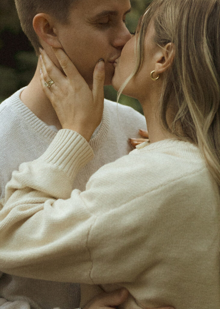 couple kissing at their redwoods engagement photos