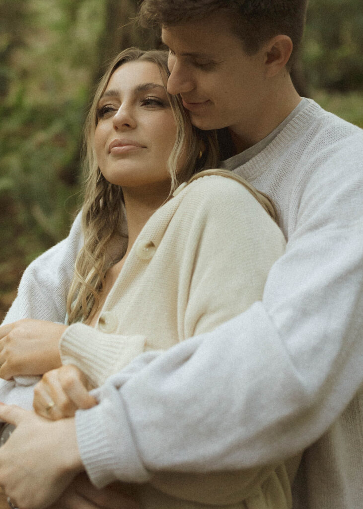 couple hugging during their redwoods engagement photos 