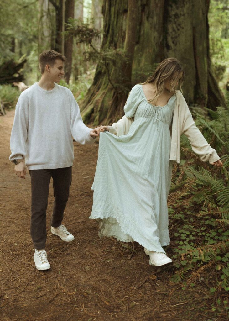 couple walking during their redwoods engagement photos 