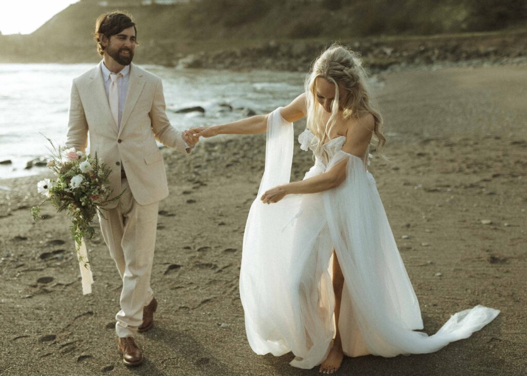 couple taking photos at the beach for their Oregon wedding 