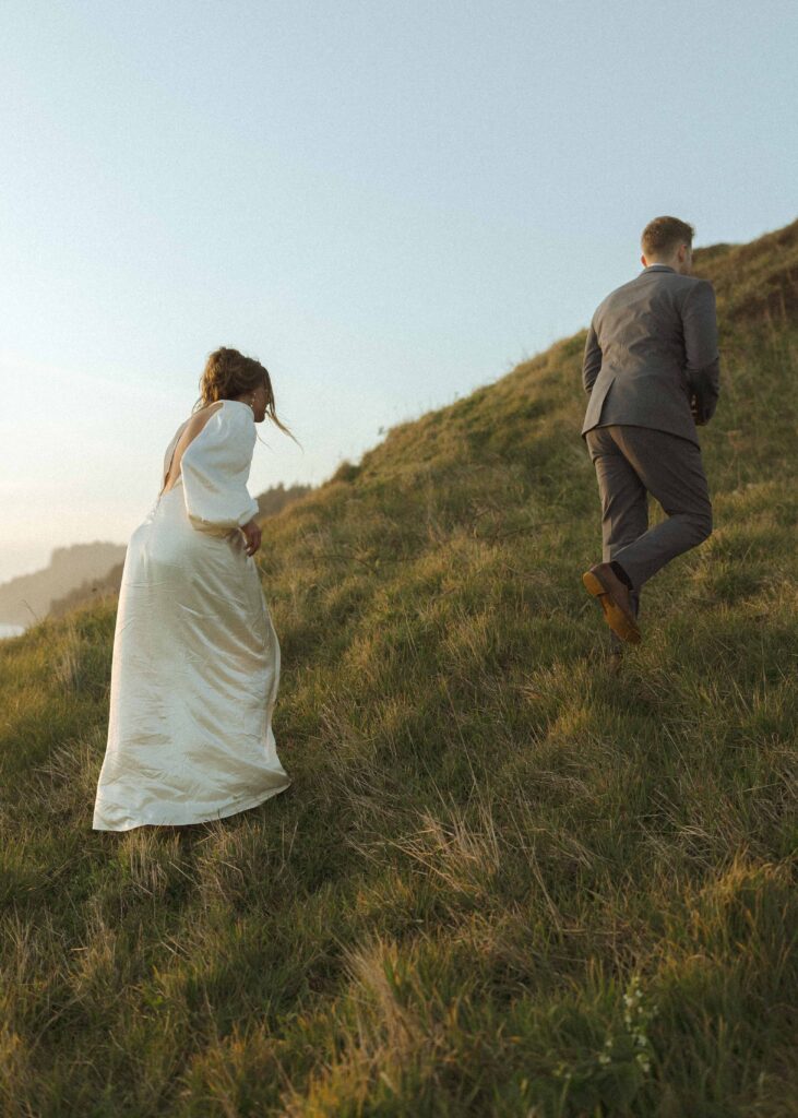 couple walking in the grass for their Oregon wedding 