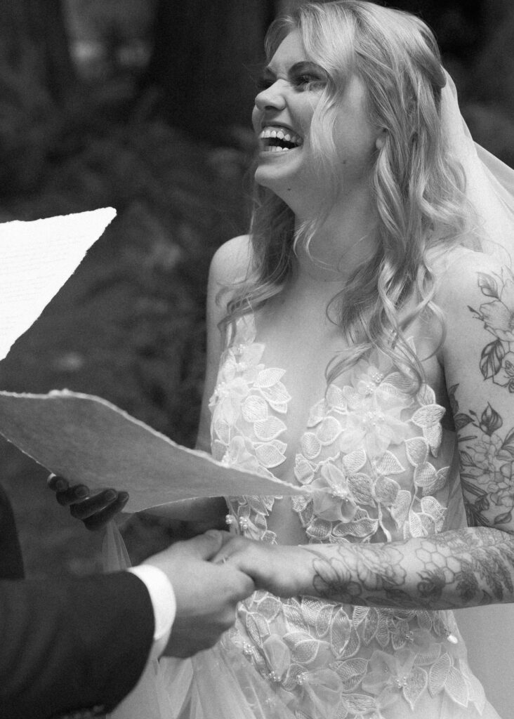 bride and groom reading their vows for their forest elopement 