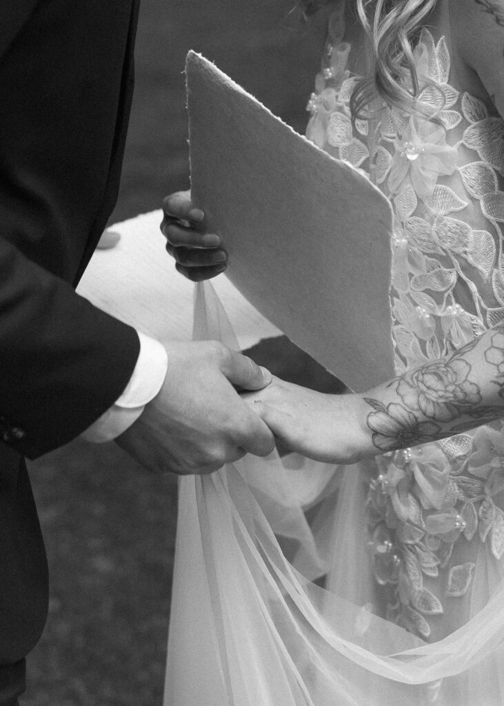 bride and groom reading their vows for their forest elopement 