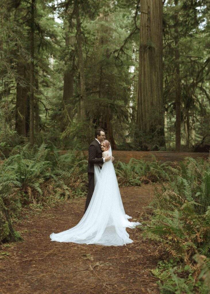 bride and groom taking wedding photos for their forest elopement 