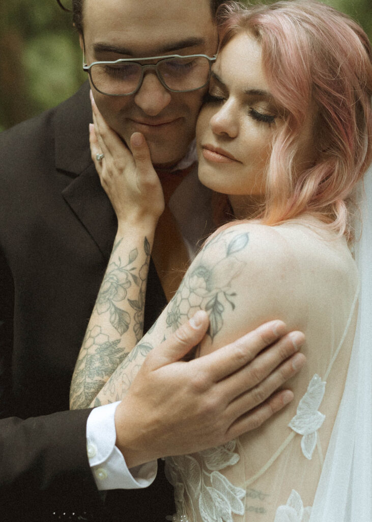 bride and groom taking wedding photos for their forest elopement 