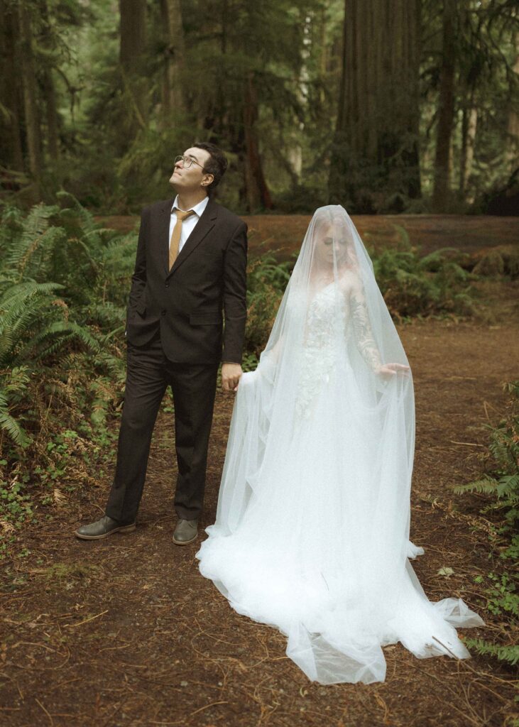 bride and groom taking wedding photos for their forest elopement 