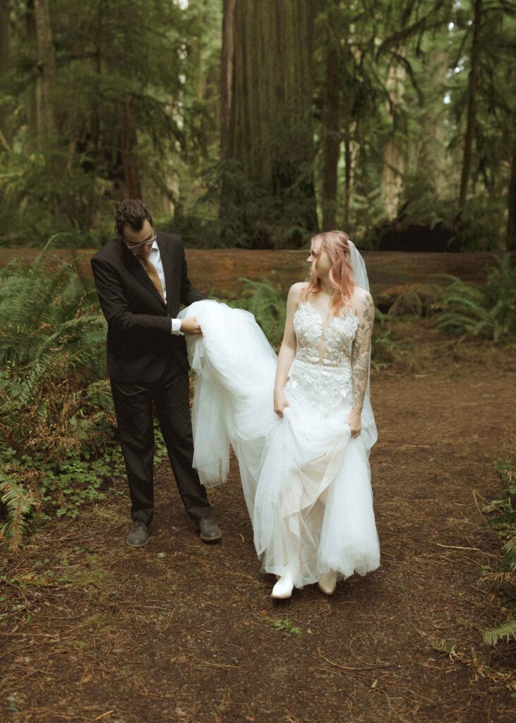 bride and groom walking on trail for their forest elopement 