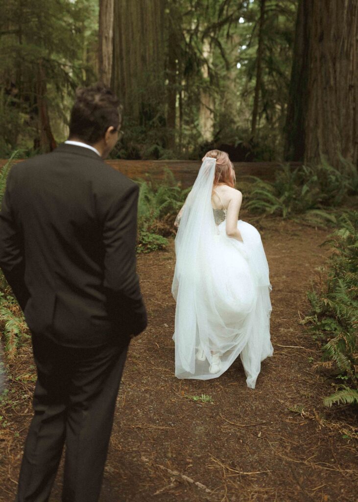 bride and groom taking wedding photos for their forest elopement 