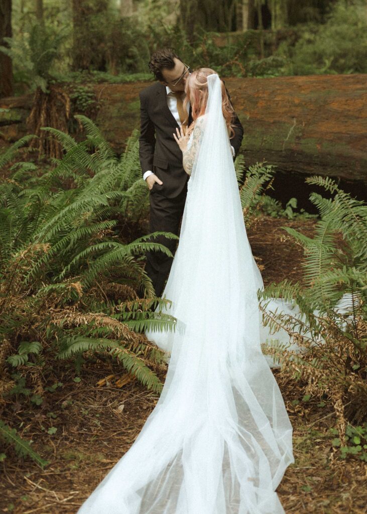 bride and groom taking wedding photos for their forest elopement 